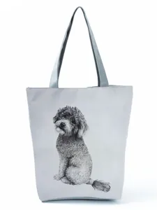 Close-up showing the artistic black and white poodle print on this large gray tote bag.