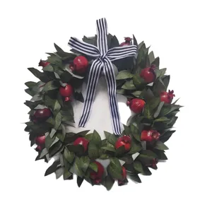 Artificial fall pomegranate wreath with striped ribbon bow for home wall decor hanging.
