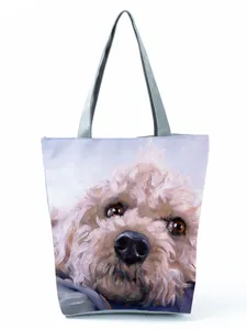 Close-up of large capacity tote bag featuring a cute poodle portrait oil painting print.
