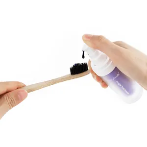 GlorySmile V34 purple teeth whitening serum being applied to bamboo toothbrush