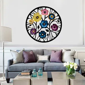 Laser-cut metal wall art with colorful flowers displayed over a living room sofa