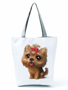 Detail view of white tote bag featuring cute Yorkshire Terrier puppy print with a red bow