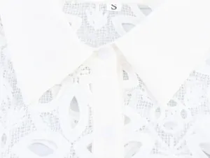Macro view of white water-soluble lace shirt featuring elegant lapel collar and embroidery