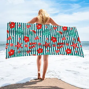 Vibrant microfiber beach towel with tropical flower and starfish print at the beach.
