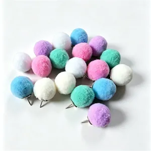 A detailed macro view of colorful soft pompom push pins for office cork boards