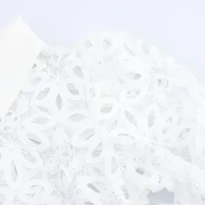 Close-up view of elegant white water-soluble lace blouse featuring French-style lapel collar