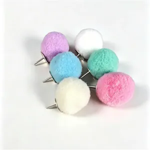 Close-up detail showing texture and colors of fuzzy pom-pom decorative push pins for office use