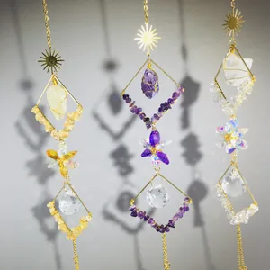 Detailed view of suncatchers with natural amethyst, quartz crystals and golden sun charms.