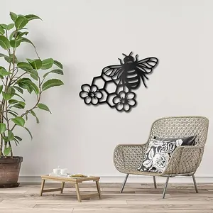 Laser cut black metal wall art featuring a bee, honeycomb, and floral accents