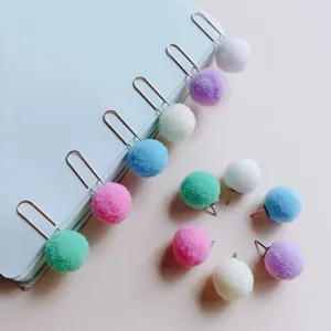 Colorful pom-pom paper clips and push pins for creative office stationery decor