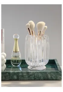 Close-up detail showing the ribbed texture of the transparent glass makeup brush holder