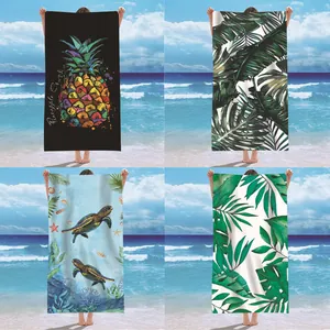 Selection of four quick-dry beach towels with tropical turtle and palm prints