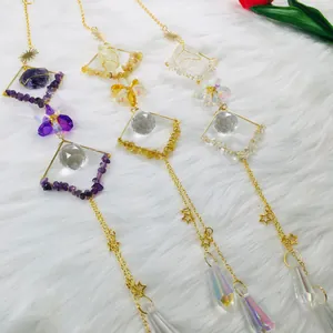 Detailed view of handmade amethyst citrine and clear quartz crystal ball suncatchers.