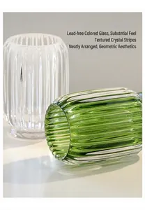 Close-up detail of green and clear ribbed glass holders for makeup brushes and pens