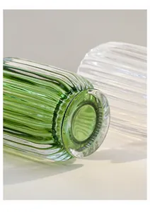 Macro view of the elegant ribbed glass texture and polished base of the makeup brush holder