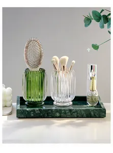 Elegant Nordic luxury ribbed glass makeup brush organizers set on a green marble tray