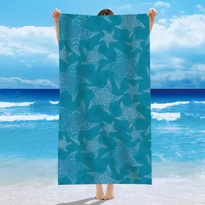 Microfiber beach towel with intricate white starfish and shell pattern on teal background