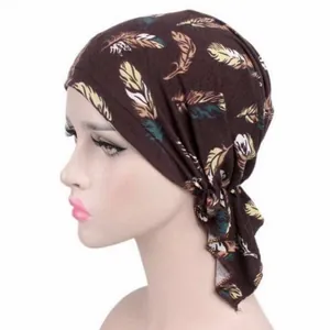 Detail of women's brown headscarf featuring a vibrant and colorful feather print pattern.