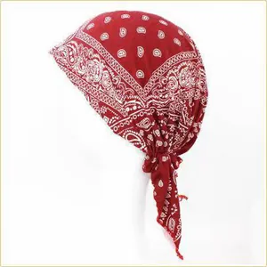 Close-up detail of a stylish red paisley printed headscarf cap for women in summer.