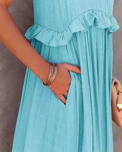 Detail shot of a blue summer maxi dress showing ruffle texture and a side pocket.