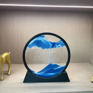 Detailed shot of the blue and white landscape sand patterns in the circular ornament.