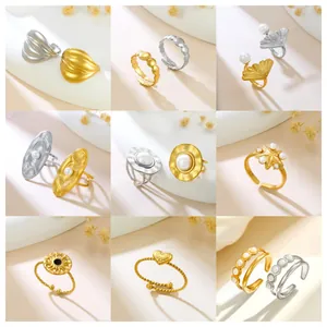 Collection of diverse stainless steel open rings in gold and silver with pearl accents