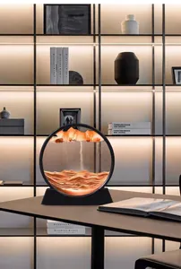Creative round moving sand art landscape ornament displayed on a modern office desk