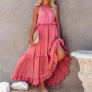 Detail showing a dusty pink tiered maxi dress with ruffles and floor-length hem.