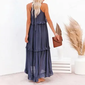 Detailed back view of a navy blue tiered ruffle maxi dress with elegant halter neck tie