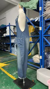 Side view profile of retro washed blue loose oversized denim overalls on a mannequin