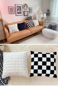 Close-up detail of luxury black and white checkerboard and textured plush throw pillows