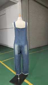 Macro view showing the vintage wash and back detail of the loose denim overalls