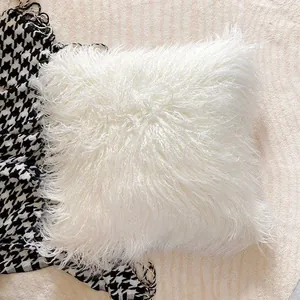 Detailed close-up view of a white shaggy faux fur cushion for luxury sofa home decor