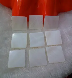Detail view of square iridescent white mother of pearl shell pieces for DIY jewelry