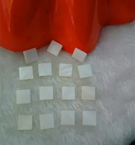 Macro detail of natural square white mother of pearl shell pieces for DIY jewelry.