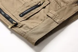 Macro view of cargo pants showing durable cotton fabric and metal zipper detail