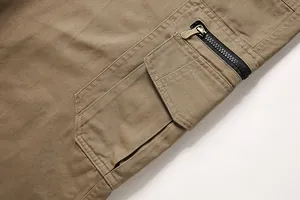 Detailed close-up of men's cargo pants featuring a sturdy zipper and large utility pocket