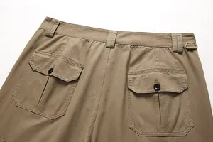Detailed macro view of back buttoned pockets on khaki cotton cargo pants for men