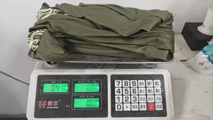 Vue détaillée d'une robe longue verte sur une balance numérique indiquant un poids de 0,410 kg