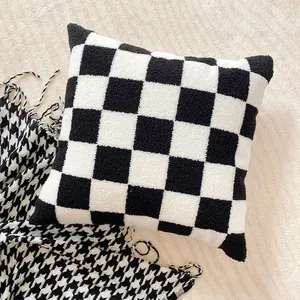 Elegant black and white checkered plush cushion cover featuring soft faux rabbit fur texture