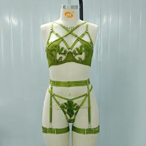 Green embroidered mesh lingerie set with garter belt shown on a display mannequin