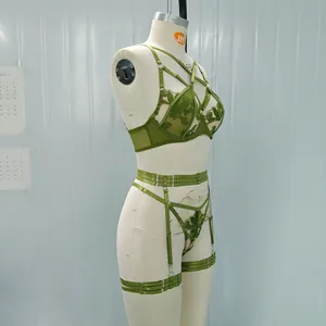 Dark green embroidered mesh lingerie set with strappy garter belt on a mannequin