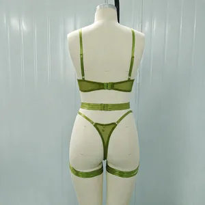 Detailed back view of a green mesh lingerie set including garter belt on a mannequin torso