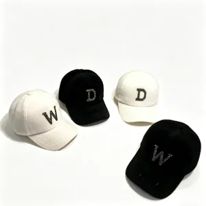 Group of black and white mink fur baseball caps with rhinestone letter details
