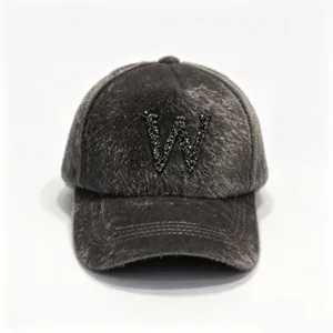 Detailed view of luxury grey faux fur baseball cap featuring a black rhinestone W letter