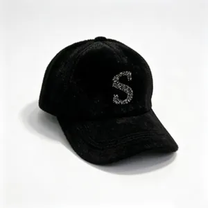 Close-up of black faux mink fur baseball cap with rhinestone letter S detail
