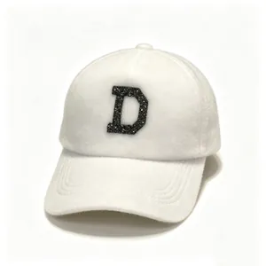 Close-up detail of white faux fur baseball cap featuring a black sequined D patch.