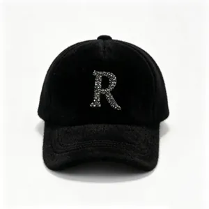 Premium black faux mink fur baseball cap featuring a sparkling rhinestone R letter patch