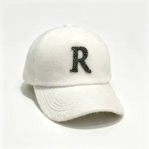 Elegant white faux mink fur baseball cap featuring a sparkling rhinestone letter R detail