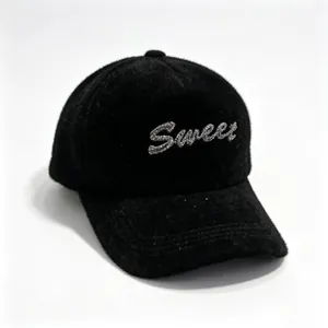 Close-up of black mink fur baseball cap with glittering rhinestone 'Sweet' text